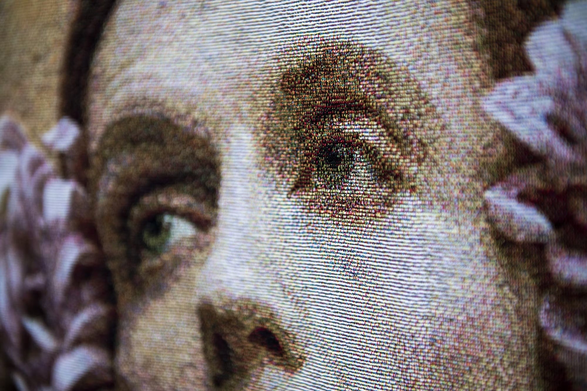 Close-up of woven tapestry portrait details
