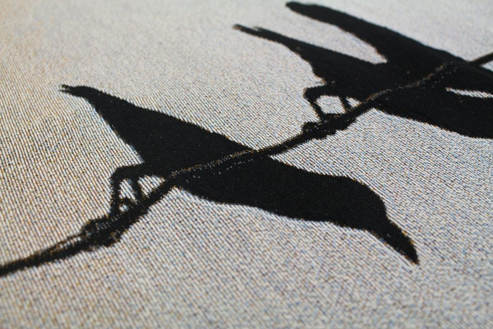 Silhouetted birds on woven fabric