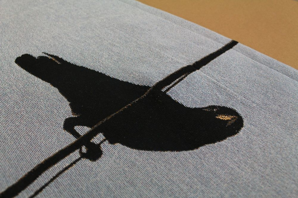 Woven fabric with a crow design
