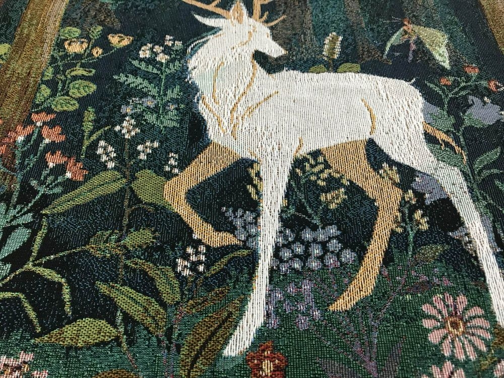 woven tapestry of a stag in nature